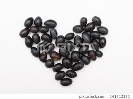 Black organic olives arranged in heart shape on white background Black organic olives arranged in heart shape on white background 141512323