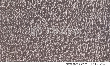 Close up of a light gray textured stucco wall with rough bumps and ridges, a subtle horizontal crack running across the upper section. Close up of a light gray textured stucco wall with rough bumps and ridges, a subtle horizontal crack running across the upper section. 141512623