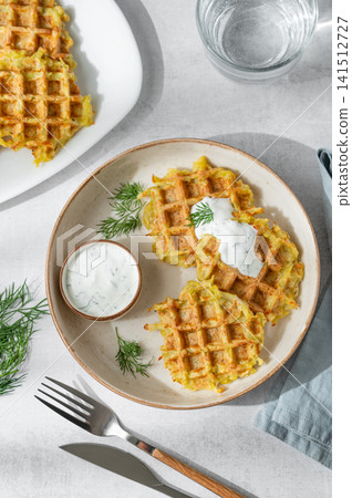 Vegetarian potato waffles with natural yogurt and dill on a plate on a light background  141512727