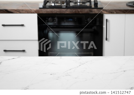 A bright kitchen with a stove and stone countertop in a minimalist style A bright kitchen with a stove and stone countertop in a minimalist style 141512747