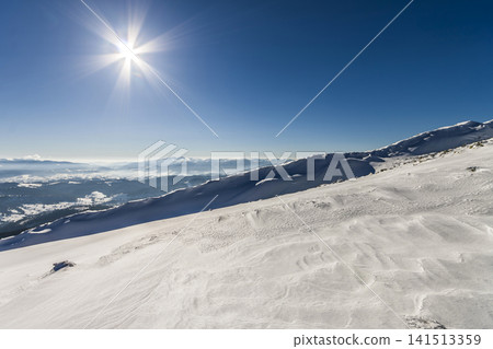 Snow covered hills in winter mountains. Arctic landscape. Colorful outdoor scene, Happy New Year celebration concept. Snow covered hills in winter mountains. Arctic landscape. Colorful outdoor scene, Happy New Year celebration concept. 141513359