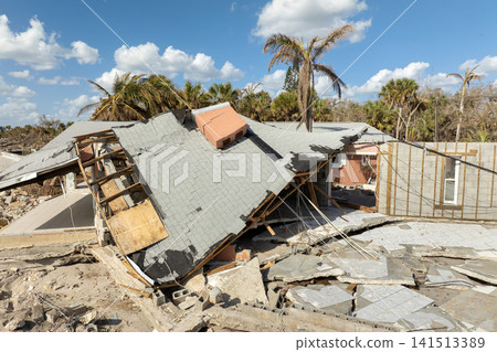 Ruined buildings in need of demolition or repair. Storm surge water and wind damaged houses roof and collapsed walls after hurricane in Florida Ruined buildings in need of demolition or repair. Storm surge water and wind damaged houses roof and collapsed walls after hurricane in Florida 141513389