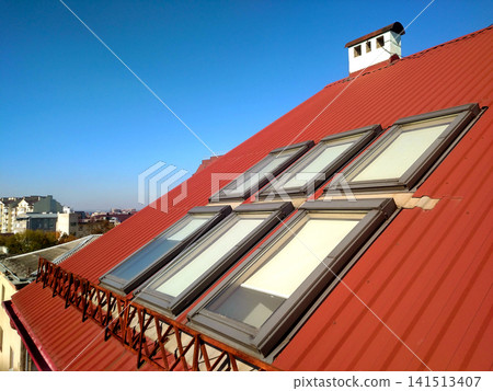 Red tiled house roof with attic windows. Roofing construction, window installation, modern architecture concept. Red tiled house roof with attic windows. Roofing construction, window installation, modern architecture concept. 141513407