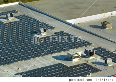 Photovoltaic solar panels mounted on industrial building roof for producing green ecological electricity. Production of sustainable energy concept 141513475