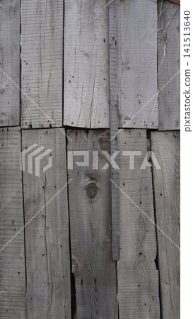 Close-up of weathered gray wooden planks arranged vertically, showing rustic, distressed texture, aging concept. Close-up of weathered gray wooden planks arranged vertically, showing rustic, distressed texture, aging concept. 141513640