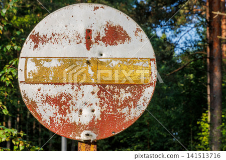 Closeup of a heavily rusted and faded no entry traffic sign beside a forest road near Vilniemi in Hamina, Finland Closeup of a heavily rusted and faded no entry traffic sign beside a forest road near Vilniemi in Hamina, Finland 141513716
