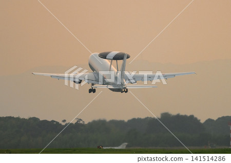A Japan Air Self-Defense Force E-767 early warning and control aircraft takes off at dusk. A Japan Air Self-Defense Force E-767 early warning and control aircraft takes off at dusk. 141514286