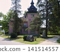 Historic building surrounded by trees in a rural area 141514557