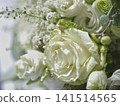 White roses and green flowers in a floral arrangement 141514565