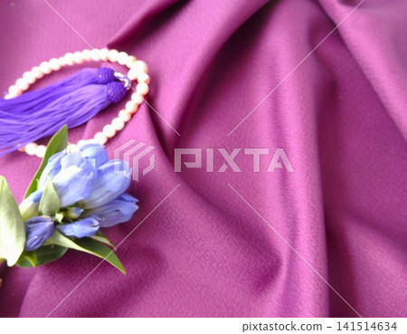 Flowers and prayer beads placed on a cloth Flowers and prayer beads placed on a cloth 141514634