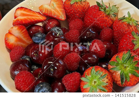 Delicious strawberries and blueberries served on a plate Delicious strawberries and blueberries served on a plate 141515828