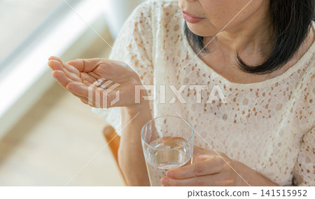 Woman taking medicine Woman taking medicine 141515952