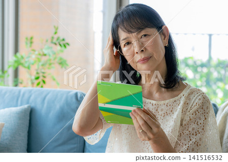 Senior woman shocked after seeing her bankbook Senior woman shocked after seeing her bankbook 141516532