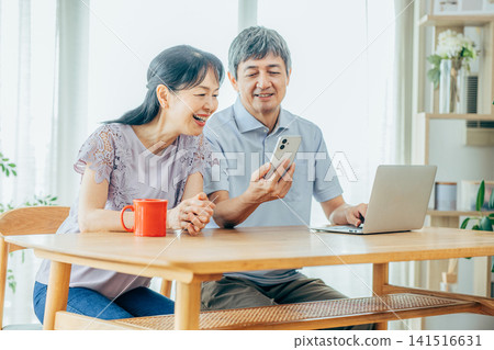 Senior couple watching a smartphone Senior couple watching a smartphone 141516631