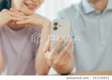 Senior couple watching a smartphone Senior couple watching a smartphone 141516632