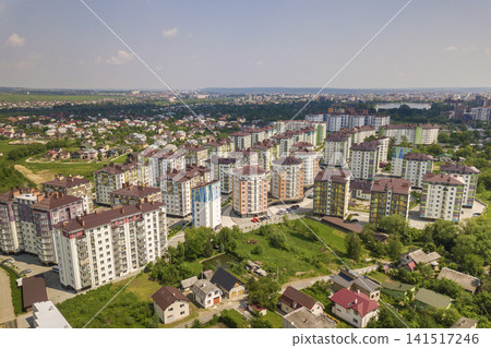 Top view of urban developing city landscape with tall apartment buildings and suburb houses. Drone aerial photography. Top view of urban developing city landscape with tall apartment buildings and suburb houses. Drone aerial photography. 141517246