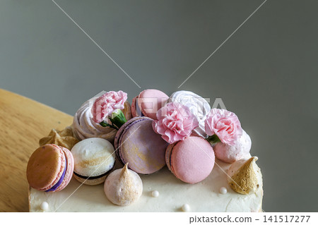 Sweet colorful cake with french macaroons on top Sweet colorful cake with french macaroons on top 141517277