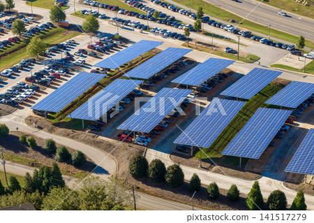 Sustainable power production integrated in urban infrastructure. Photovoltaic solar panels over car parking place for generation of renewable energy. Sustainable power production integrated in urban infrastructure. Photovoltaic solar panels over car parking place for generation of renewable energy. 141517279