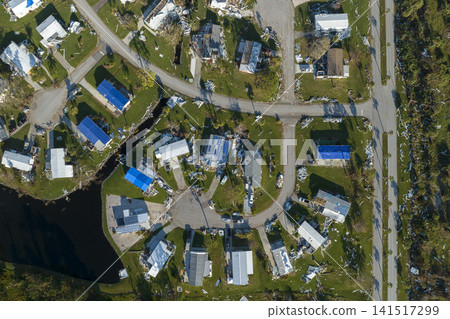 Strong hurricane winds severely damaged private houses in Florida mobile home residential area. Consequences of natural disaster 141517299