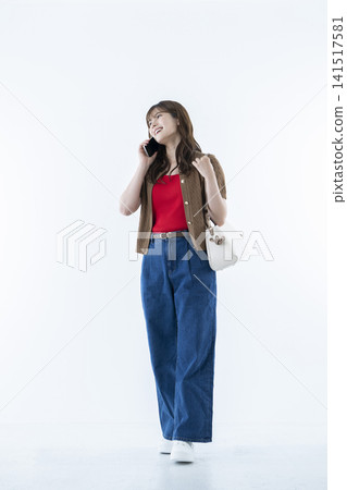 Young woman talking on a smartphone Young woman talking on a smartphone 141517581