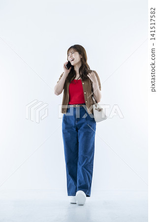 Young woman talking on a smartphone Young woman talking on a smartphone 141517582