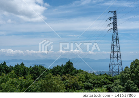 A spectacular panoramic view of the deep green mountains of Unzen, power transmission towers, and the Ariake Sea, Nagasaki. A spectacular panoramic view of the deep green mountains of Unzen, power transmission towers, and the Ariake Sea, Nagasaki. 141517806