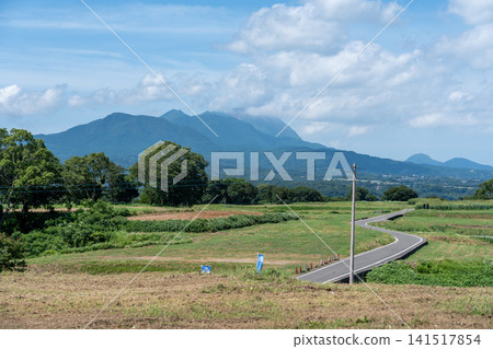 Winding farm roads across the plateau with the Unzen mountain range towering in the background. Nagasaki. Winding farm roads across the plateau with the Unzen mountain range towering in the background. Nagasaki. 141517854