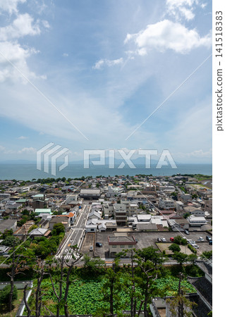 A vertical composition of the Shimabara landscape, capturing a straight street, a lotus pond, and the Ariake Sea. A vertical composition of the Shimabara landscape, capturing a straight street, a lotus pond, and the Ariake Sea. 141518383