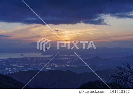 A breathtaking view of the sunset from Mount Ibuki: A beautiful twilight landscape overlooking the mountains and Lake Biwa. A breathtaking view of the sunset from Mount Ibuki: A beautiful twilight landscape overlooking the mountains and Lake Biwa. 141518532