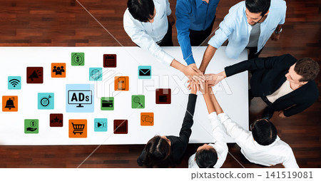 Team Collaboration Over a Table with Marketing Icons and Hands Aligning for a Successful Business Strategy Meeting. Glyphic Team Collaboration Over a Table with Marketing Icons and Hands Aligning for a Successful Business Strategy Meeting. Glyphic 141519081