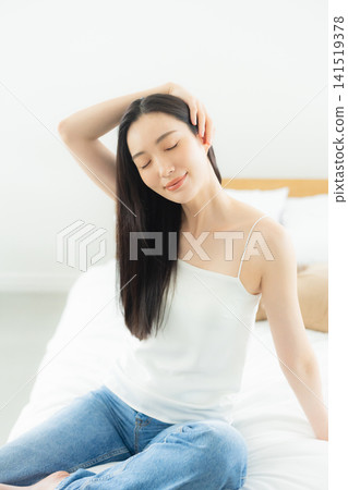 A woman relaxing in the bedroom A woman relaxing in the bedroom 141519378