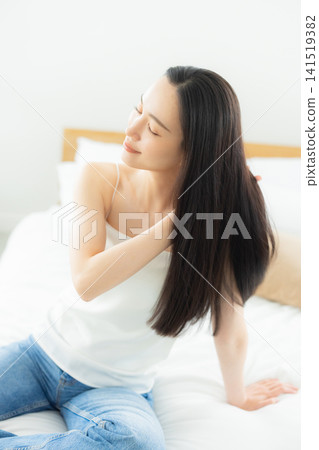 A woman relaxing in the bedroom A woman relaxing in the bedroom 141519382