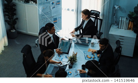 Top view of female leader looking financial statistic at meeting. Directorate. Top view of female leader looking financial statistic at meeting. Directorate. 141519646