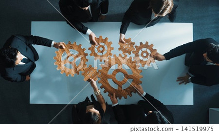 Top view of business team bring filled last cog to complete system. Directorate. Top view of business team bring filled last cog to complete system. Directorate. 141519975