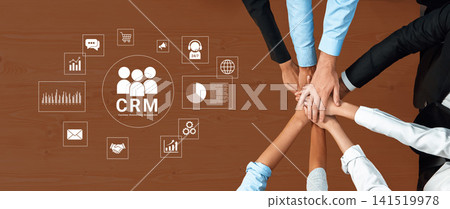 Collaborative Business Team Working on Customer Relationship Management Concepts with Hands Together on Table. Glyphic Collaborative Business Team Working on Customer Relationship Management Concepts with Hands Together on Table. Glyphic 141519978