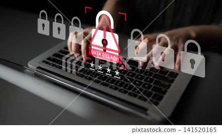 Hands Typing on Laptop with Data Breach Alert and Security Symbols Representing Cyber Threats and Digital Safety Concerns in Modern Technology Environment Ledger 141520165
