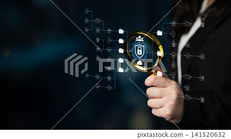 Hand Holding Magnifying Glass Highlighting Digital Security Icons with Protection Elements and Data Flow in a Tech-Focused Concept for Privacy and Analysis. Sentient Hand Holding Magnifying Glass Highlighting Digital Security Icons with Protection Elements and Data Flow in a Tech-Focused Concept for Privacy and Analysis. Sentient 141520632