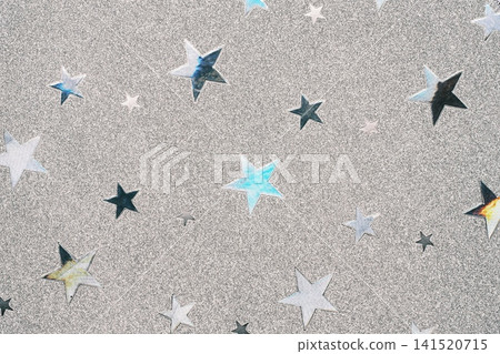 背景圖片為一張帶有星形圖案的金屬色紙張的特寫。 141520715
