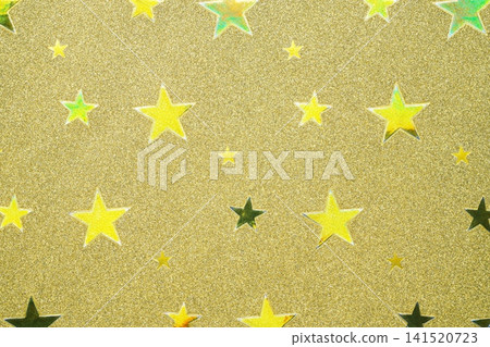 A background image featuring a close-up of metallic colored paper with a star pattern. 141520723