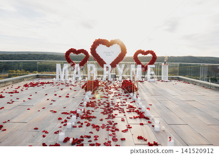 Romantic proposal scene unfolds on a rooftop terrace Romantic proposal scene unfolds on a rooftop terrace 141520912