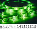 Green LED strip light close-up with glowing diodes 141521818