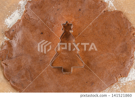 Christmas Tree Cookie Cutter on Gingerbread Dough for Holiday Baking Christmas Tree Cookie Cutter on Gingerbread Dough for Holiday Baking 141521860
