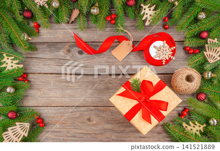 Christmas Gift with Festive Decoration on Rustic Wooden Background Christmas Gift with Festive Decoration on Rustic Wooden Background 141521889