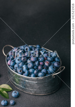 Fresh Blueberries in Rustic Metal Bowl on Dark Background Vertical Composition 141521916