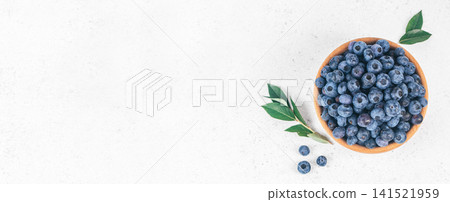 Fresh Blueberries in Wooden Bowl on White Background with Copy Space Fresh Blueberries in Wooden Bowl on White Background with Copy Space 141521959