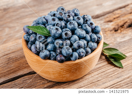 Fresh Blueberries in Wooden Bowl on Rustic Wooden Table 141521975