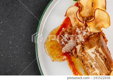Honey Cake Dessert with Honeycomb and Apple Chips on White Plate 141522036