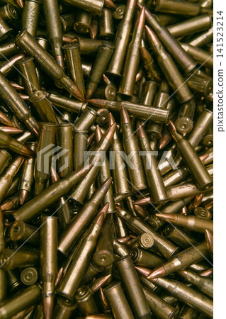Bullets background. Texture of bullets. Close-up shot. Bullets background. Texture of bullets. Close-up shot. 141523214