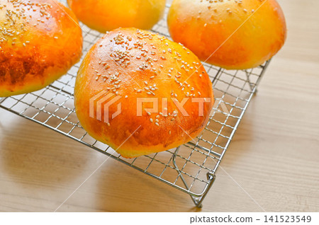 Homemade sweet bean paste bun with white sesame seed topping Homemade sweet bean paste bun with white sesame seed topping 141523549