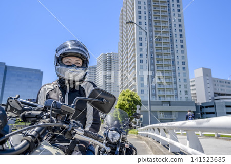 A female rider smiles in Minato Mirai. A female rider smiles in Minato Mirai. 141523685